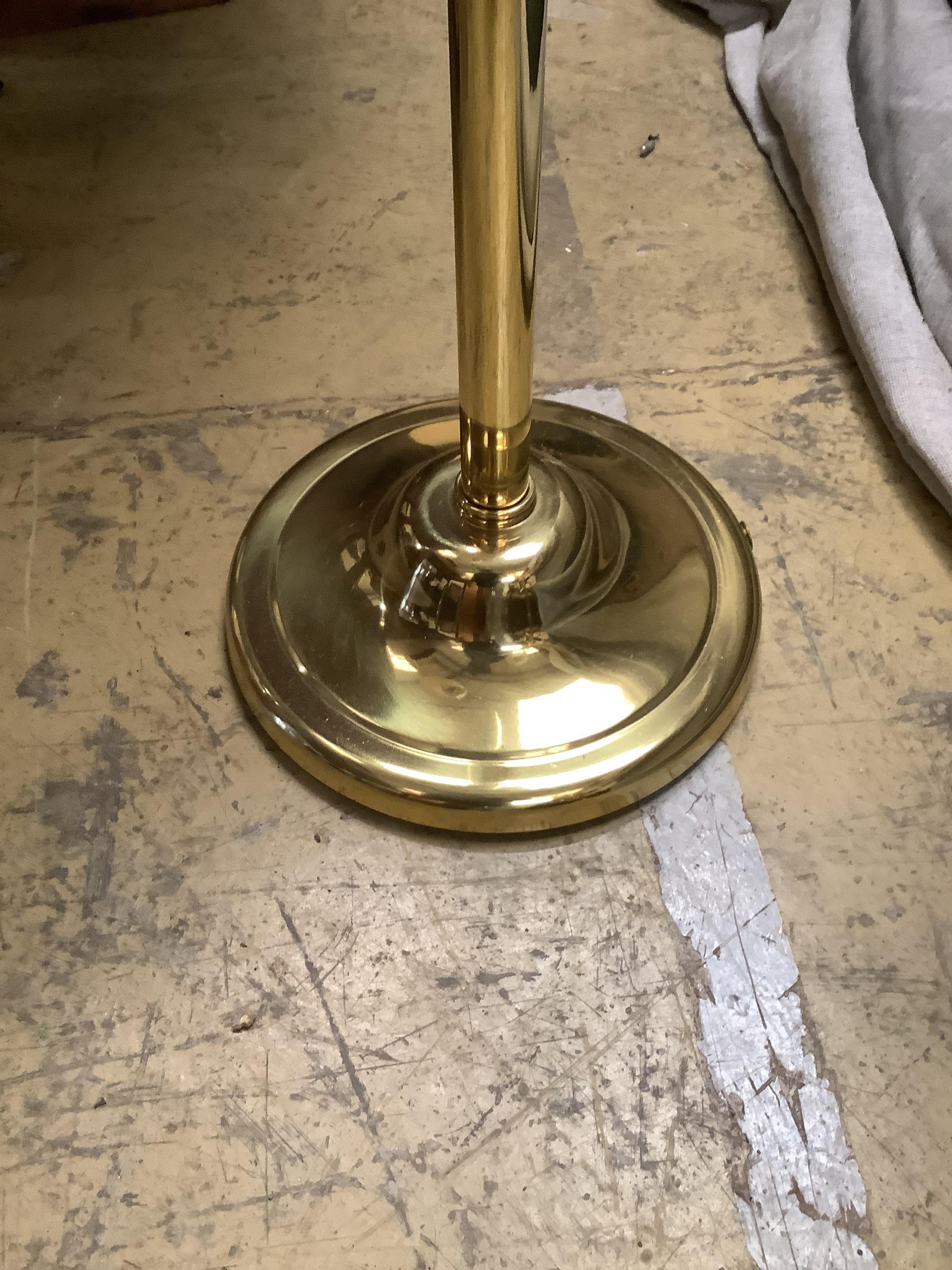 A pair of gold-coloured metal adjustable floor lamps